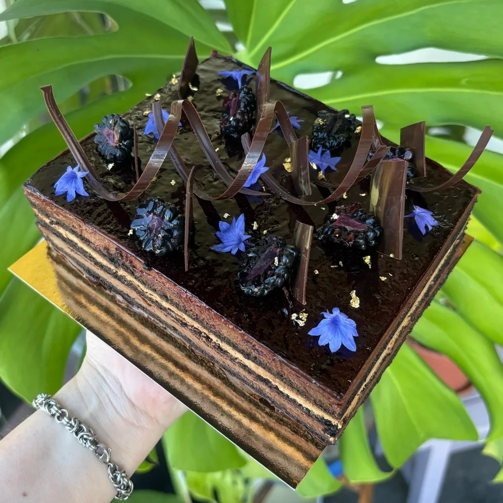 Double chocolate blackberry cake with chocolate curls and cornflowers