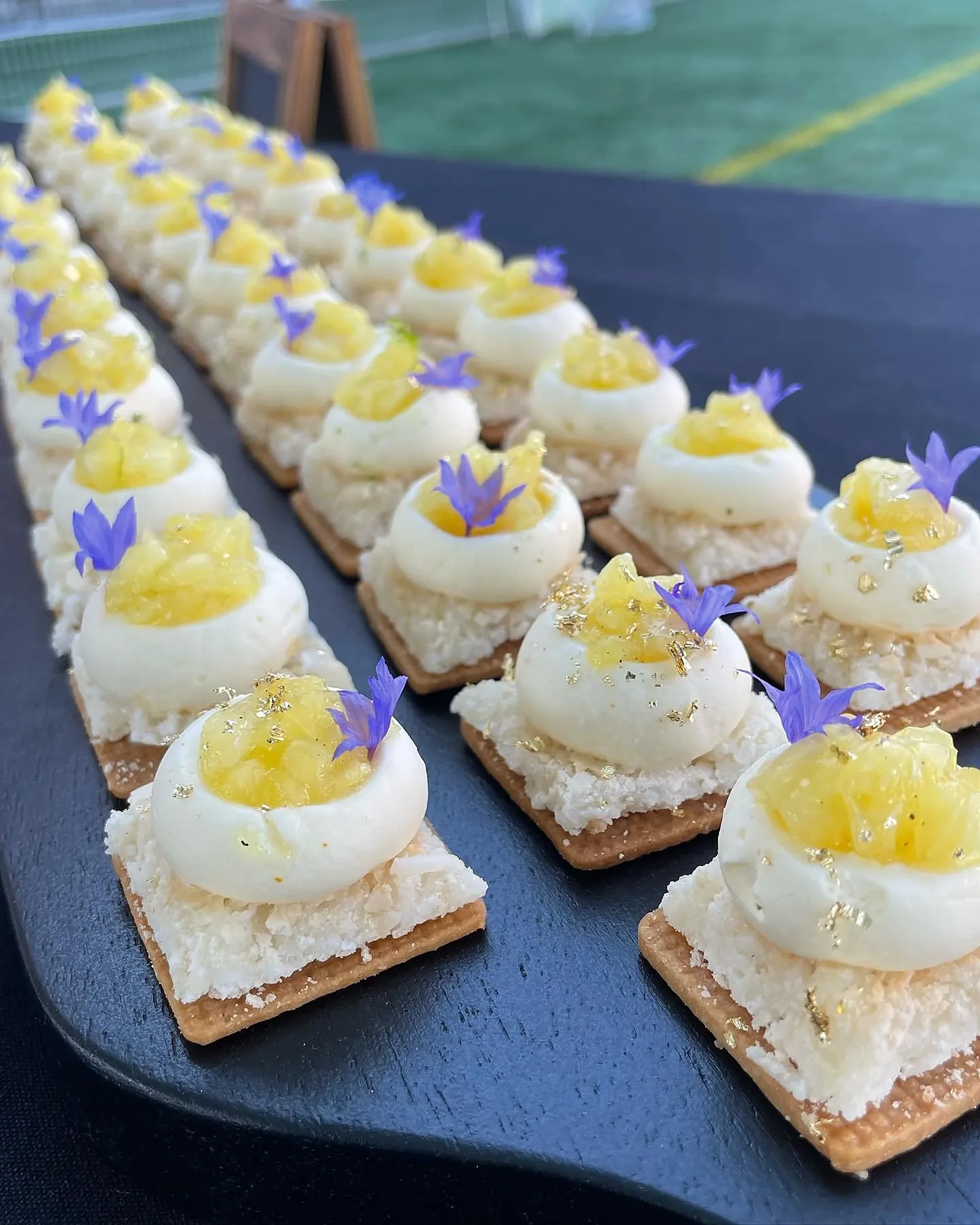 Rows of GoodSide pastries with lemon curd, cream and cornflowers